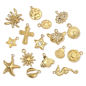 Detailed set of gold plated titanium steel charms including shell, cross and seahorse shapes