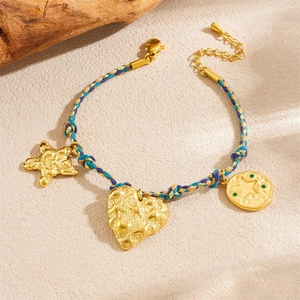 Detail of bohemian hand-woven bracelet with gold starfish and heart charms in blue and yellow