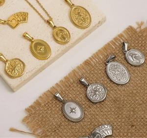 Detailed view of vintage gold and silver stainless steel pendants with embossed icons
