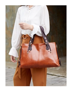 Detailed view of a stylish brown leather shoulder bag, showcasing its large capacity and design.