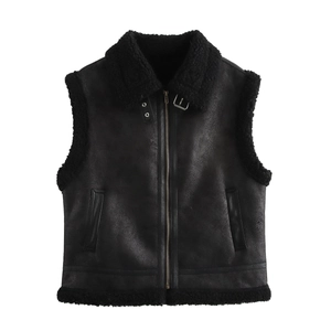 Detail of black faux suede and shearling vest featuring zip closure and wide lapels