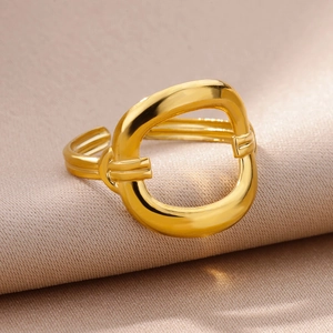 Macro shot of 18k gold plated irregular hollow ring on elegant silk background