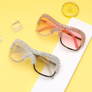 Macro detail of oversized rhinestone sunglasses with metal frames and sparkling crystal decor