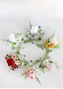 Detail view of wedding boutonnieres featuring artificial roses and satin ribbon trim