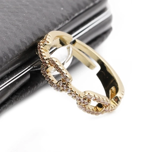 Macro shot of gold-plated chain link ring featuring sparkling pavé cubic zirconia details
