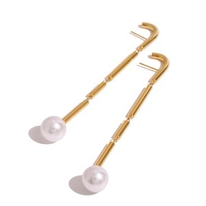 Elegant gold-tone linear tassel earrings with large white pearls on a clean background