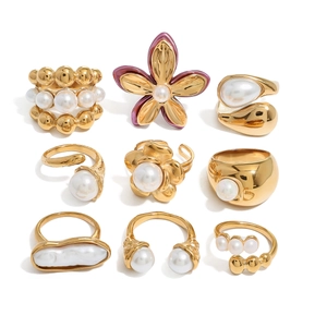 Set of 9 gold-finish stainless steel rings with white pearls and flower designs