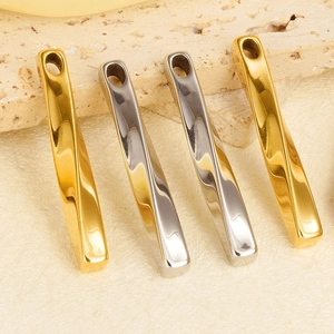 Close-up of four twisted 304 stainless steel bar pendants in gold and silver finishes