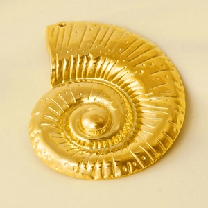 Macro detail of a golden conch shell pendant in 304 stainless steel with spiral textures