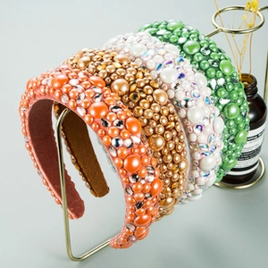 Detailed view of padded headbands featuring colorful sequins, faux pearls and rhinestones