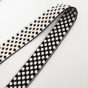 Adjustable wide shoulder strap with black and white woven pattern for crossbody handbags