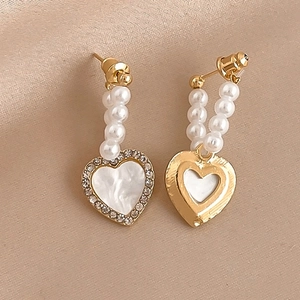 Elegant asymmetrical heart earrings with faux pearls and rhinestones on silk fabric