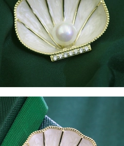 Detailed macro view of French shell brooch with white pearls and gold alloy plating
