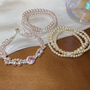 Detail of three-layer geometric pearl bracelet with zircon and pink gemstone inlay