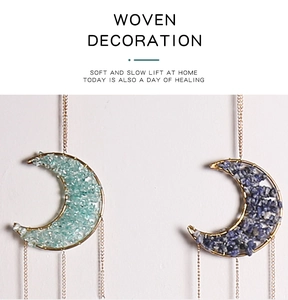 Detailed close-up of crescent moon crystal pendants with blue woven gemstones and chains