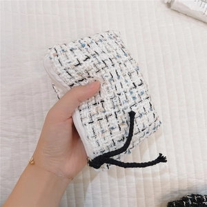 Close-up of the elegant tweed texture and zipper detail of the mini cosmetic storage pouch