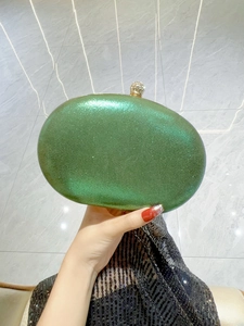 Detailed view of green peacock rhinestone evening clutch bag with sparkling finish