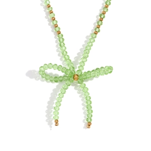 Handmade necklace with light green faceted crystals and golden steel beads bow