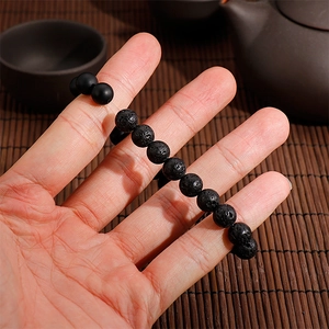 Detailed view of black lava stone and matte onyx beaded bracelet with 8mm round beads