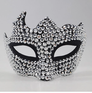 Macro detail of luxury masquerade mask featuring silver rhinestones on a black base