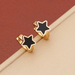 Detailed close-up of gold stainless steel hoop earrings with black oil-drop star pendants
