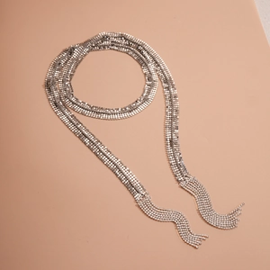 Macro detail of sparkly silver sequin mesh necklace with tiered rhinestone tassel fringes