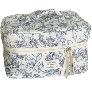 Quilted toiletry bag with monochrome ink botanical floral prints and top handle design