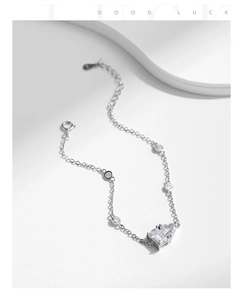 Macro detail of S925 sterling silver heart bracelet with rectangle and heart-shaped zircons