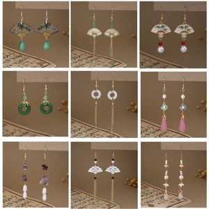 Collection of nine Neo-Chinese style butterfly pearl tassel earrings on ancient book background