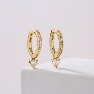18K gold plated hoop earrings with sparkling heart-shaped zircon stones on white stand