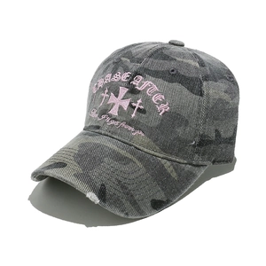 Close-up of pink embroidery and distressed brim on gray camouflage baseball cap