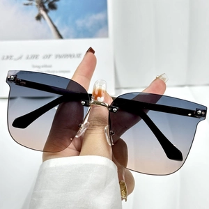 Frameless oversized gradient sunglasses for women with blue to tea lenses and gold bridge