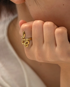 Minimalist snake-shaped open ring in polished gold finish worn by a model