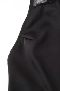 Dettaglio ravvicinato di elegante tessuto in raso nero con pizzo e cuciture fini