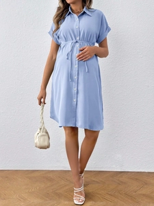 Detail of short sleeve maternity shirt dress with buttons and adjustable waist tie
