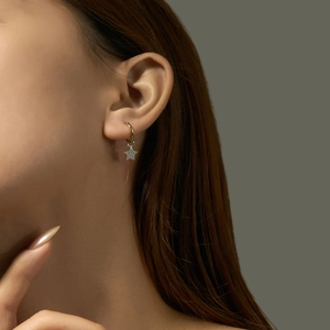 Elegant gold S925 silver star hoop earrings with sparkling cubic zirconia on model
