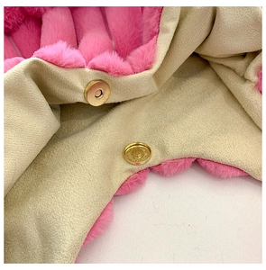 Macro view of bright pink plush faux fur tote with a gold magnetic snap closure