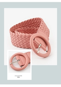 Detail of pink woven PU leather belt featuring a round buckle and silver-tone pin