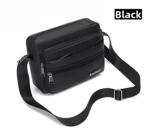 Detail view of the black multi-layer waterproof crossbody bag with adjustable strap