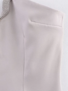 Macro shot of silver twill fabric edge with dense sparkling rhinestone embellishments