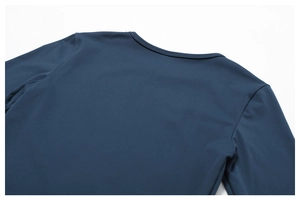 Detail of round neckline and knit texture on navy blue long-sleeve yoga top