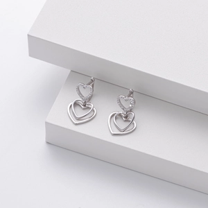 Macro shot of S925 sterling silver heart earrings with sparkling cubic zirconia pavé