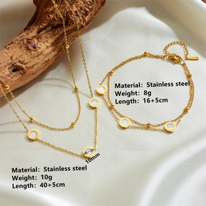 Detailed view of titanium steel necklace and bracelet set with Roman numerals and white shell