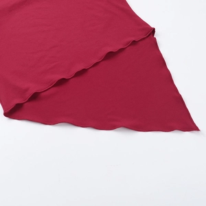 Close-up of deep red top with elegant irregular wavy lettuce edge hem and stitching detail