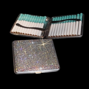 Macro view of crystal encrusted slim cigarette case with internal storage capacity