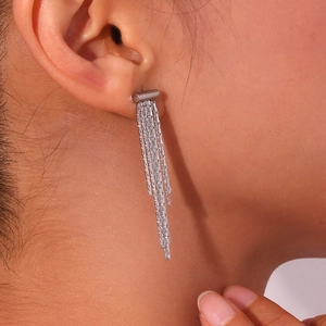 Close-up of silver multi-chain tassel earrings showing delicate metallic texture and drape