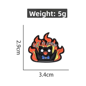 Detail showing a black cat enamel pin with LET IT BURN text and size dimensions