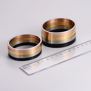Sleek brushed metal oval bangles in four colors with a convenient side buckle closure