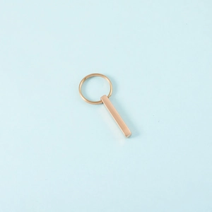 Macro shot of polished rose gold stainless steel rectangle bar keychain pendant with ring
