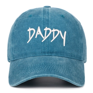 Close-up of DADDY embroidery on blue washed cotton baseball cap showing twill texture
